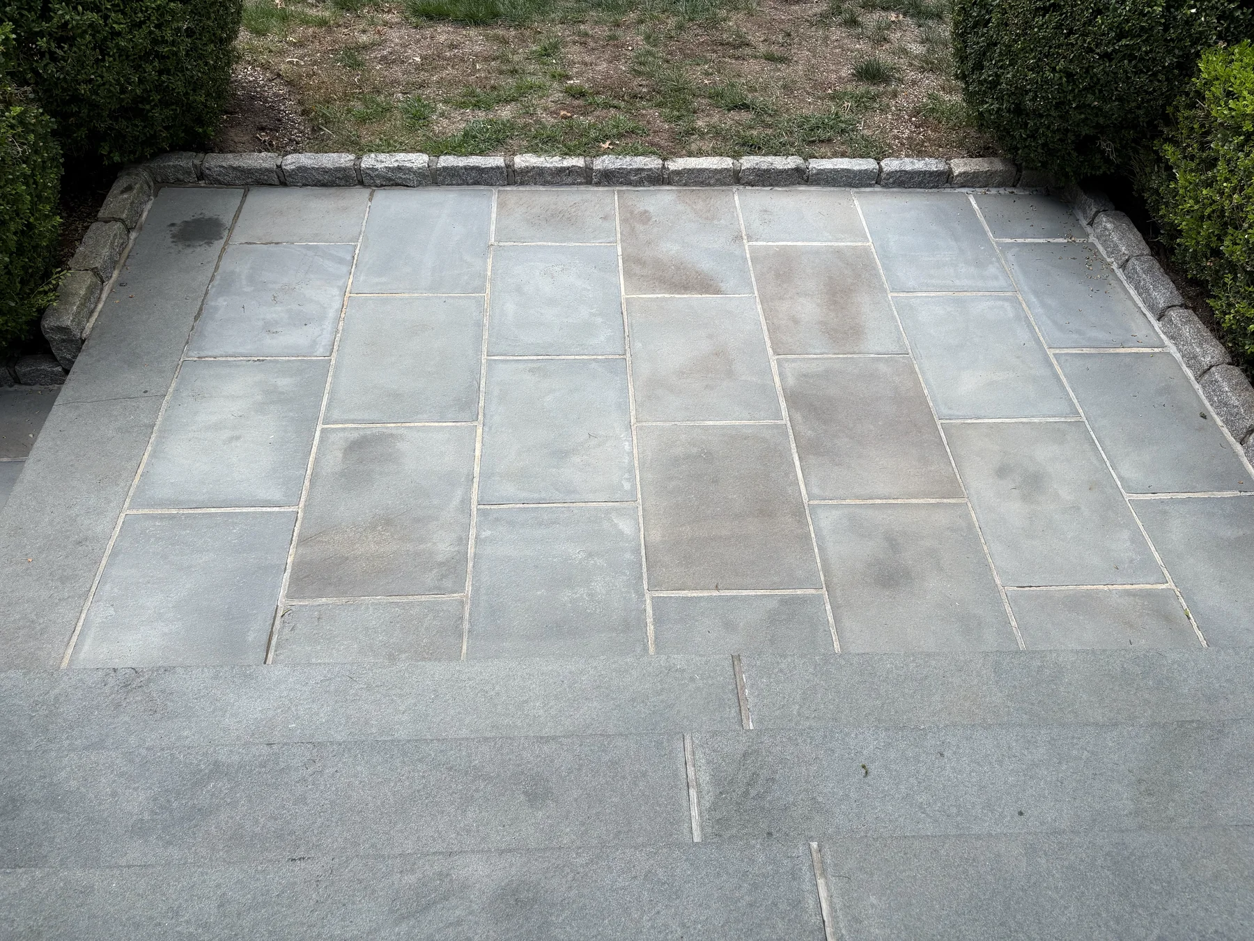 A wide bluestone patio after cleaning